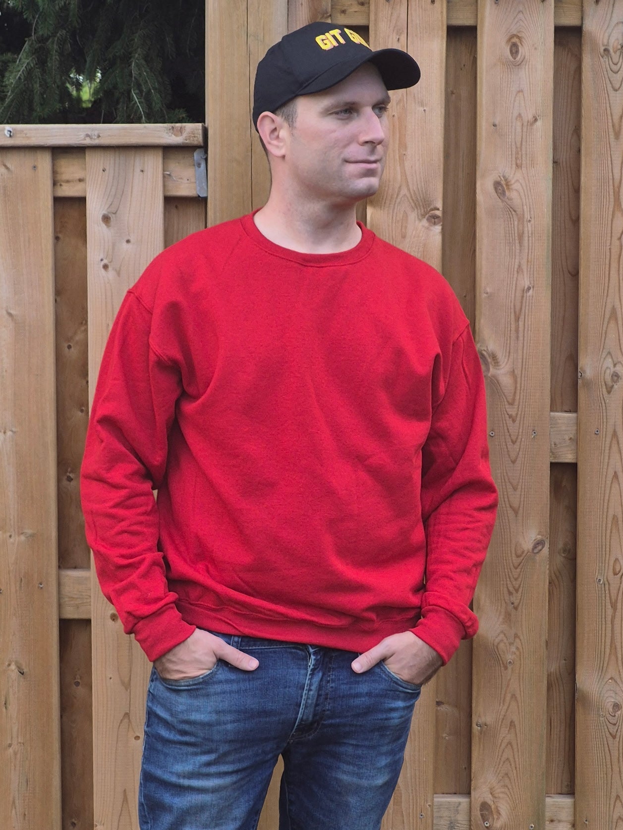 Male model wearing Red unisex sweatshirt with crewneck and long sleeves