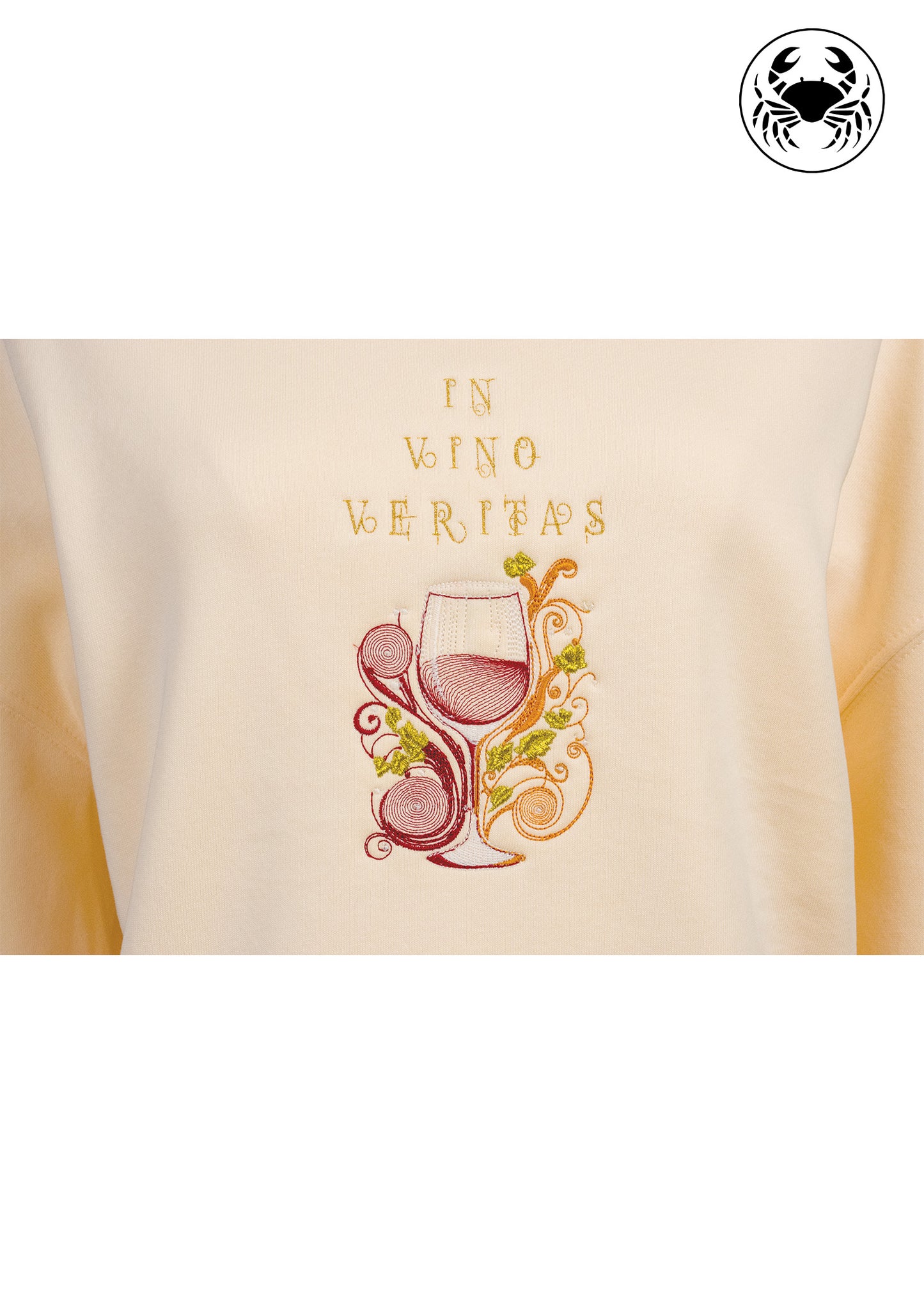Close-up of beige sweatshirt embroidery showing wine glass and swirling vine design, wine lovers’ Canadian apparel
