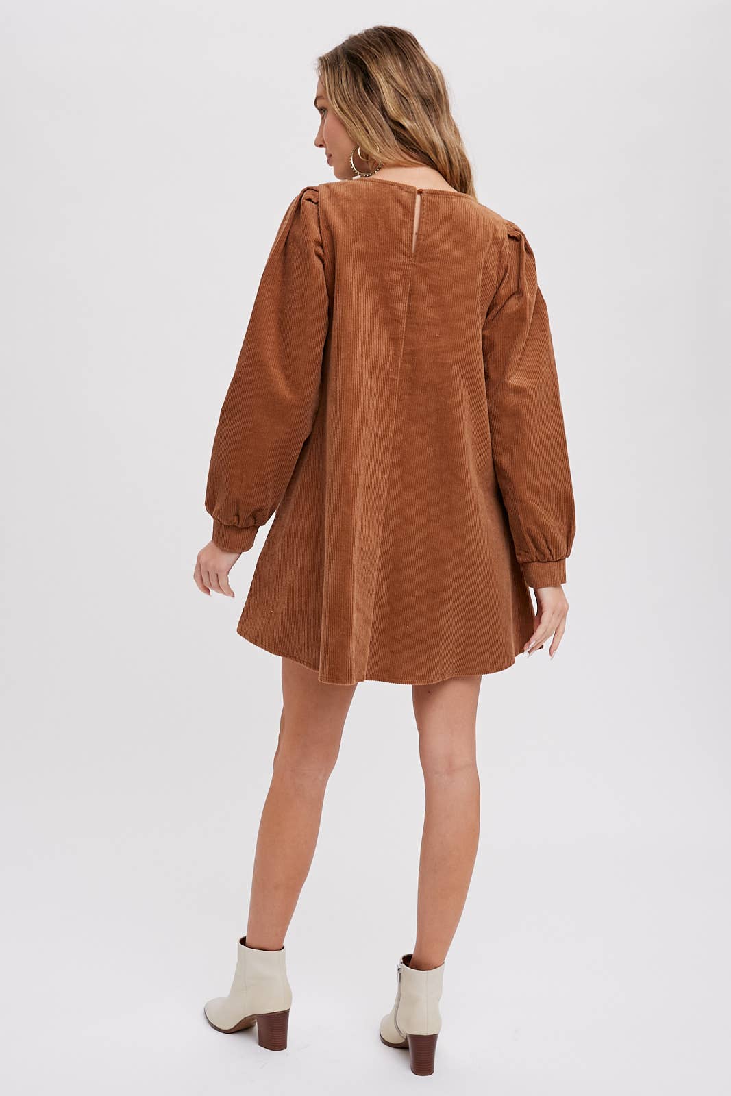 Back view of women's camel corduroy dress with long balloon sleeves, soft woven fabric