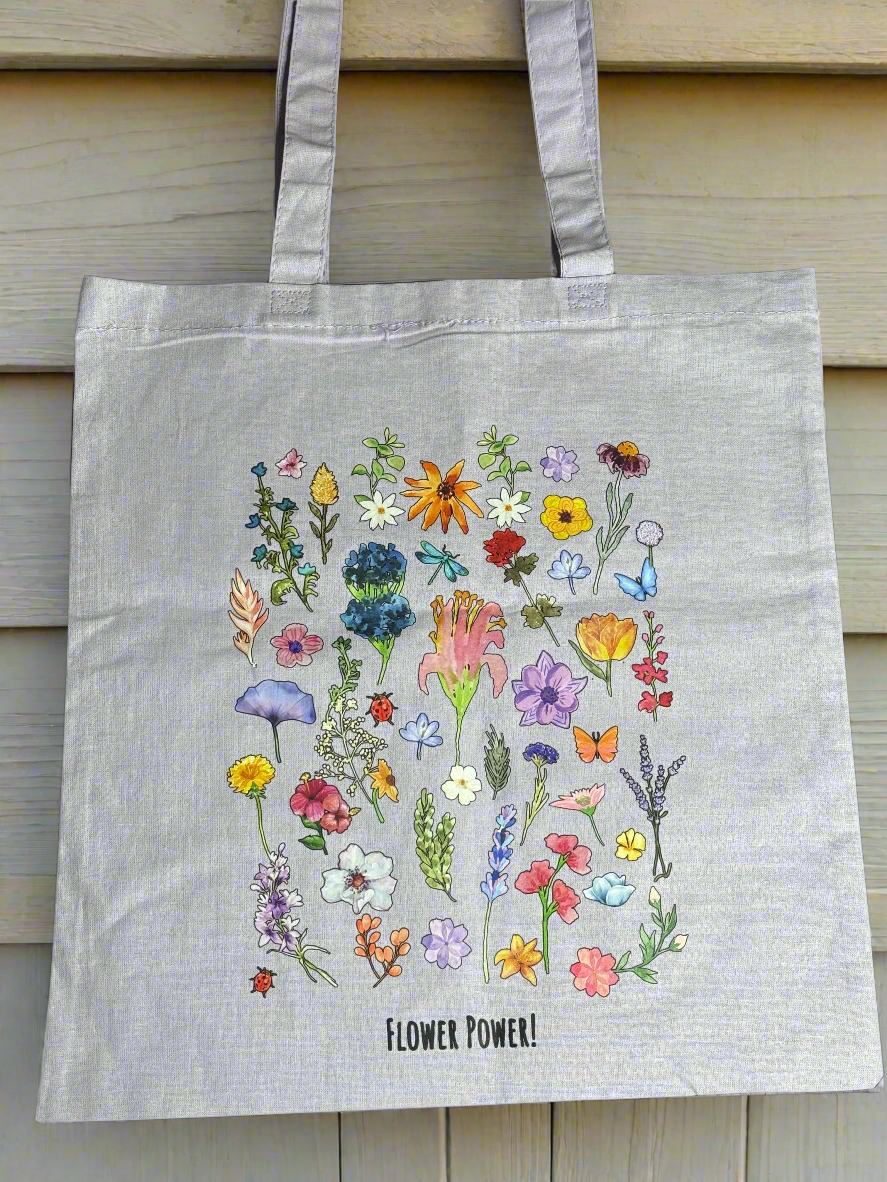 Light grey tote bag with colorful watercolor wildflowers and “Flower Power!” printed at the bottom