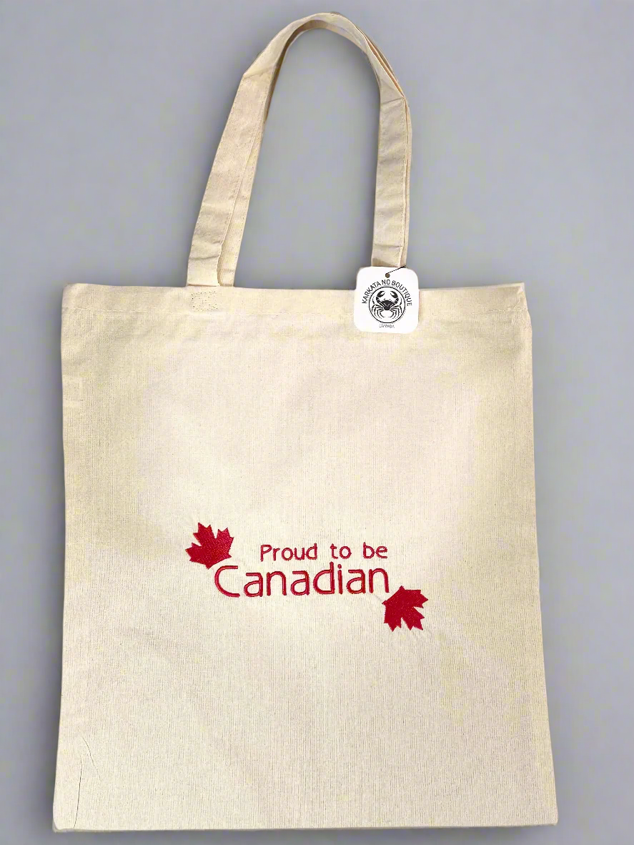 Natural cotton tote bag with “Proud to be Canadian” embroidered in red text and red maple leaves