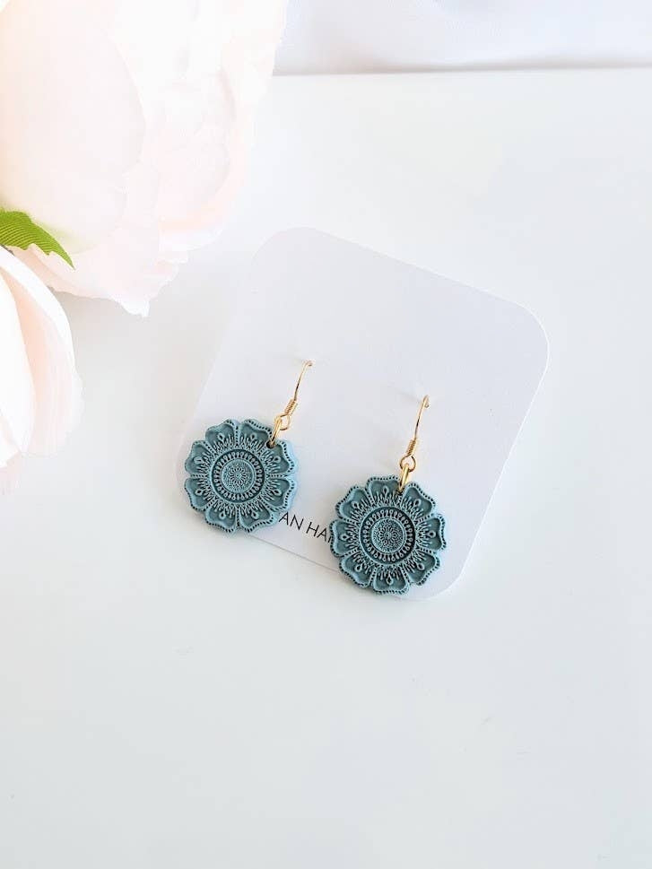 Handmade teal polymer clay earrings with intricate mandala design, lightweight and hypoallergenic, artisan jewelry crafted in Canada.