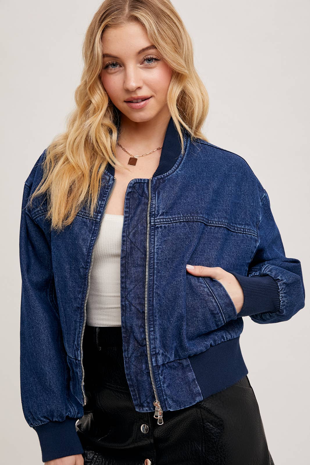 Denim blue zipper front bomber jacket for women from Karkata NC Boutique – front standing with hands in pockets