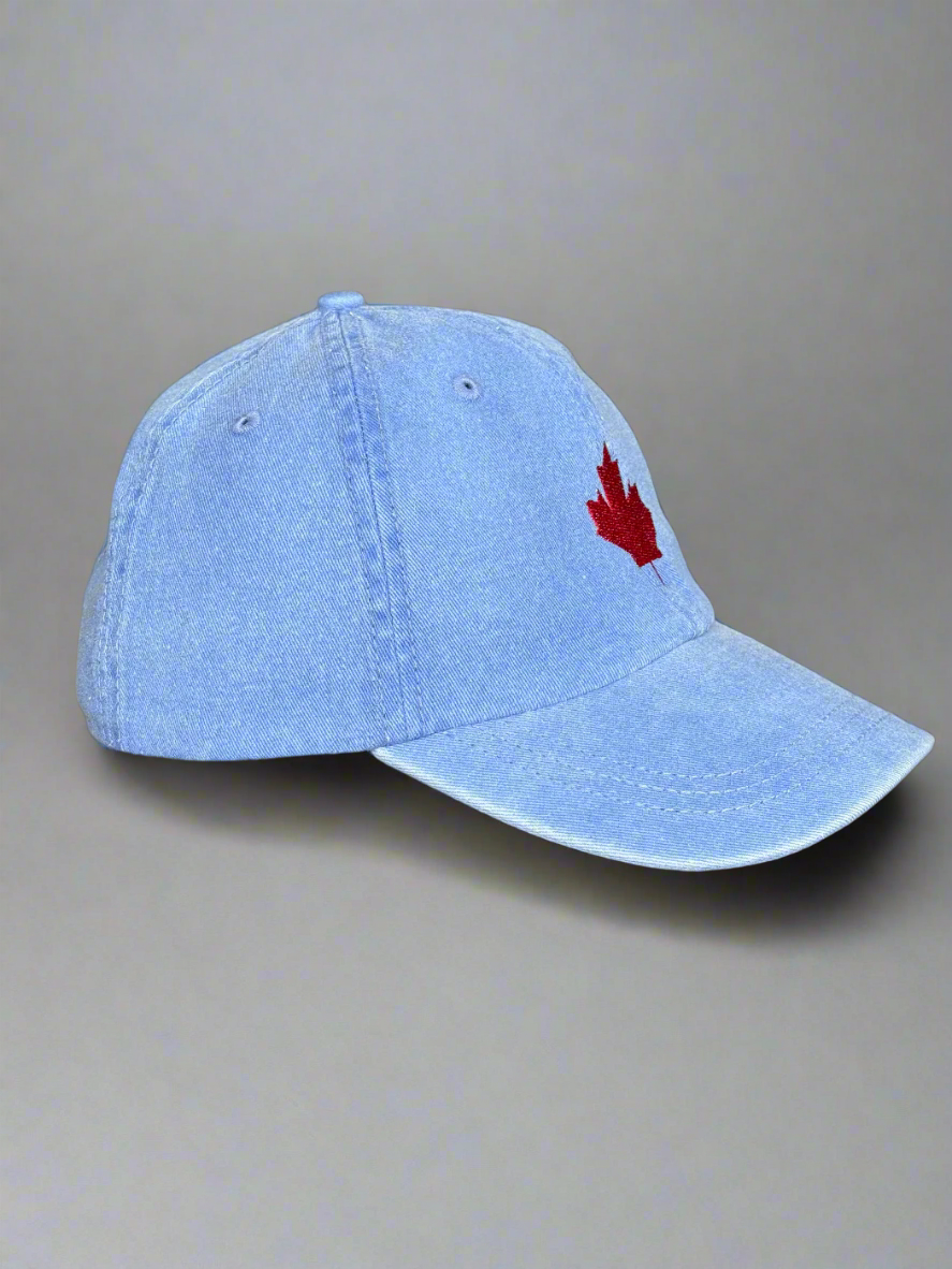 Side view of blue maple leaf hat showing red embroidery