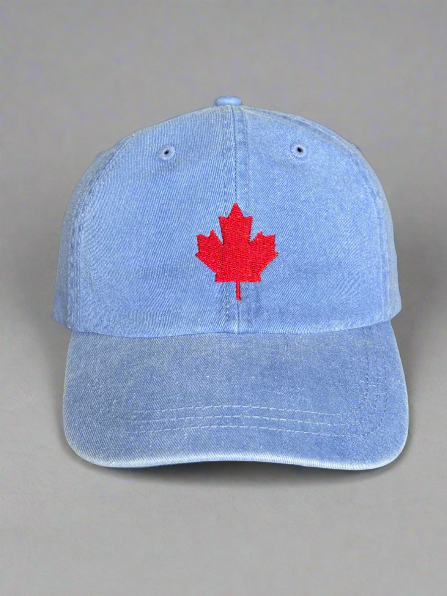 Front view of blue denim cap with red embroidered maple leaf