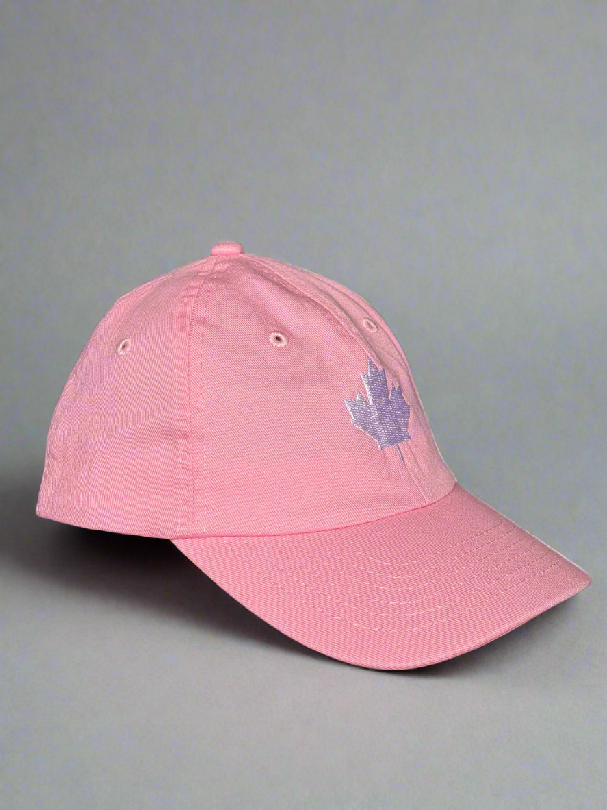 Side view of pink maple leaf cap with white embroidery