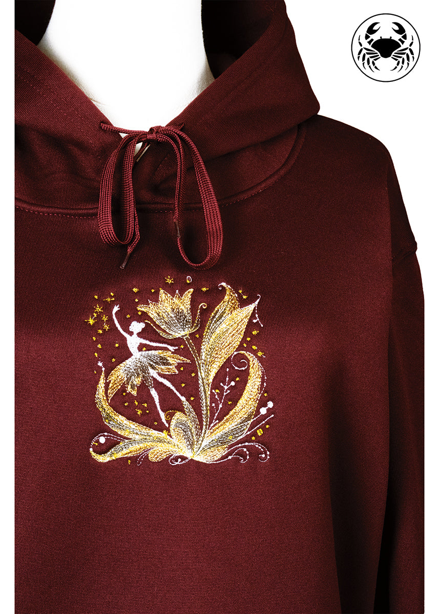 Close-up of maroon hoodie with ballerina embroidery detail, Canadian apparel