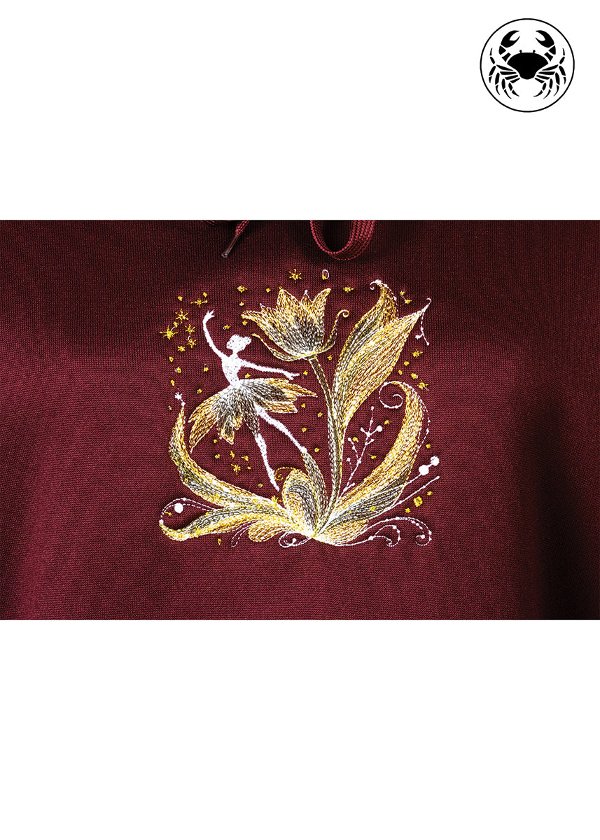 close up view of ballerina embroidery on maroon hoodie, Canadian apparel