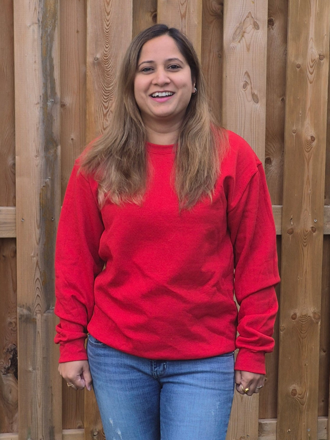 front view of Female model wearing Red unisex sweatshirt with crewneck