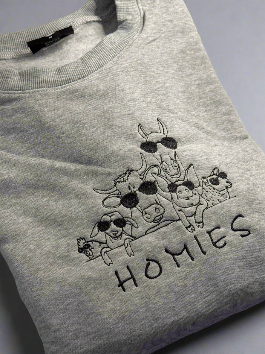 Front view of Farm Animals Homies embroidered unisex sweatshirt with playful barnyard animal lineup