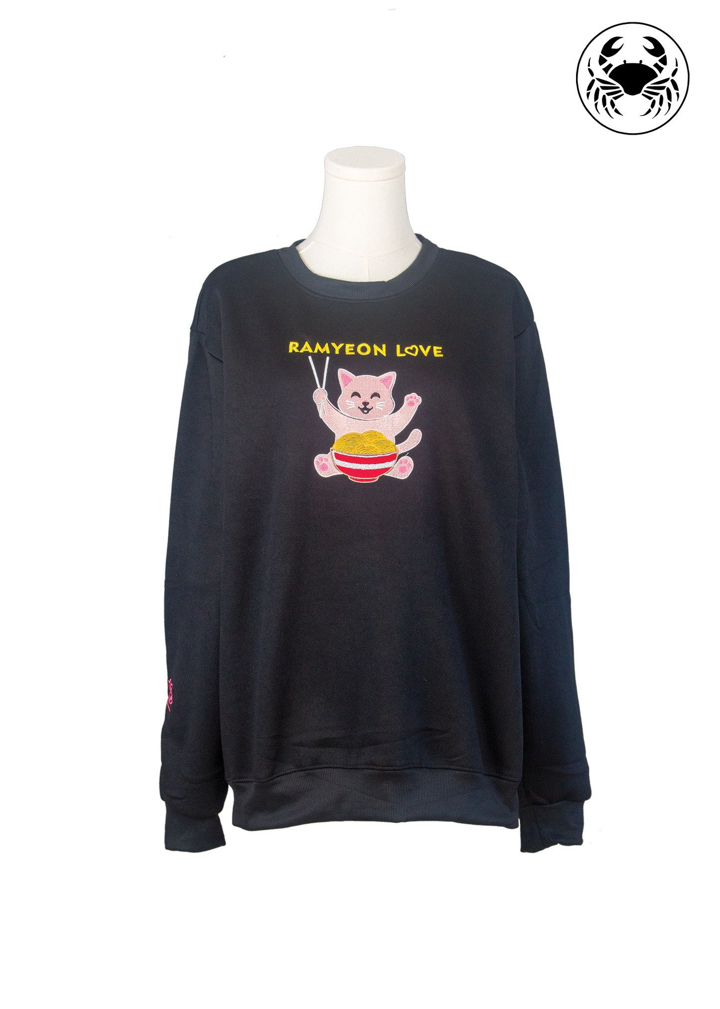 Front view of unisex black sweatshirt with kawaii embroidered ramyeon cat holding chopsticks and noodle bowl