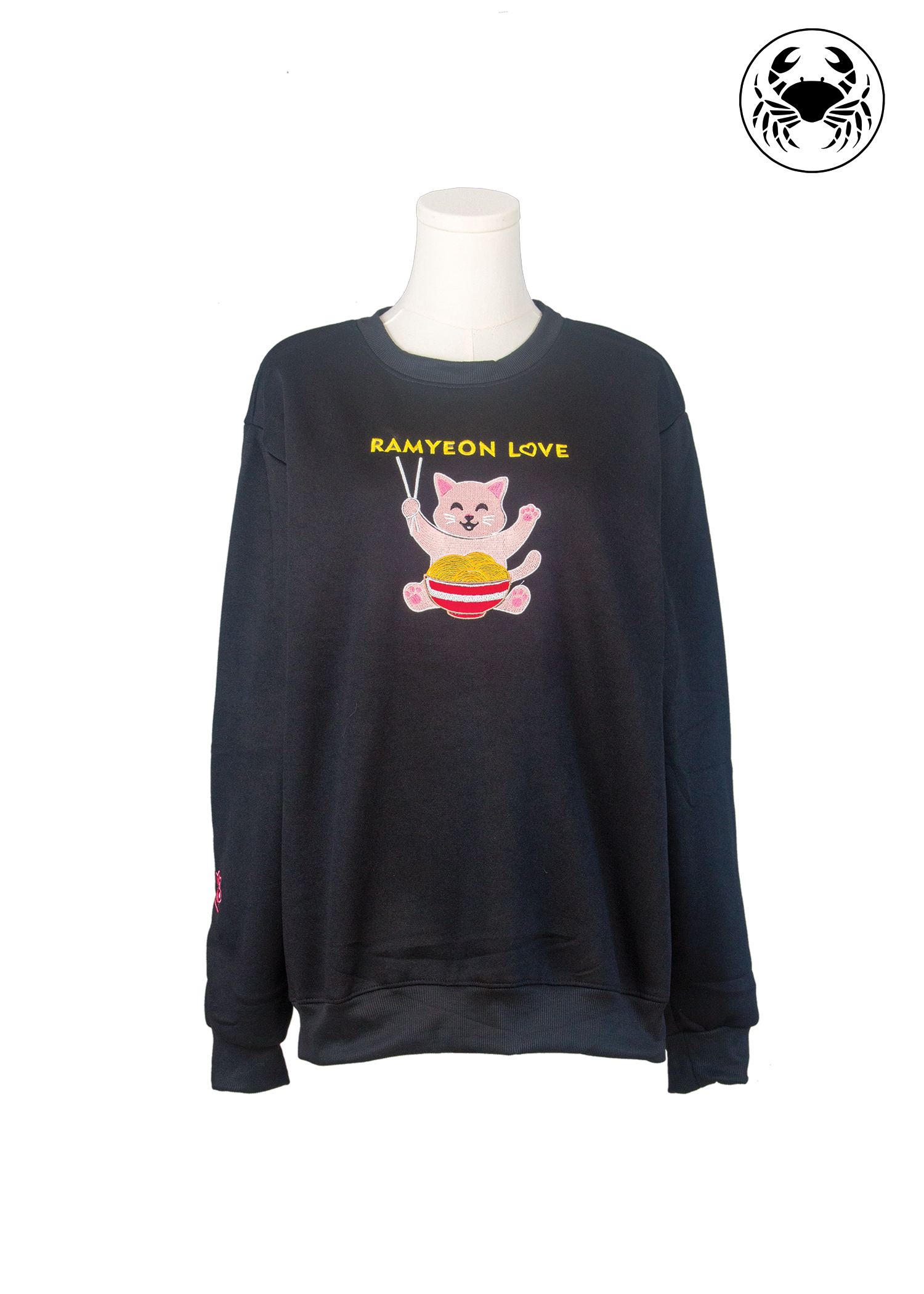 Front view of unisex black sweatshirt with kawaii embroidered ramyeon cat holding chopsticks and noodle bowl