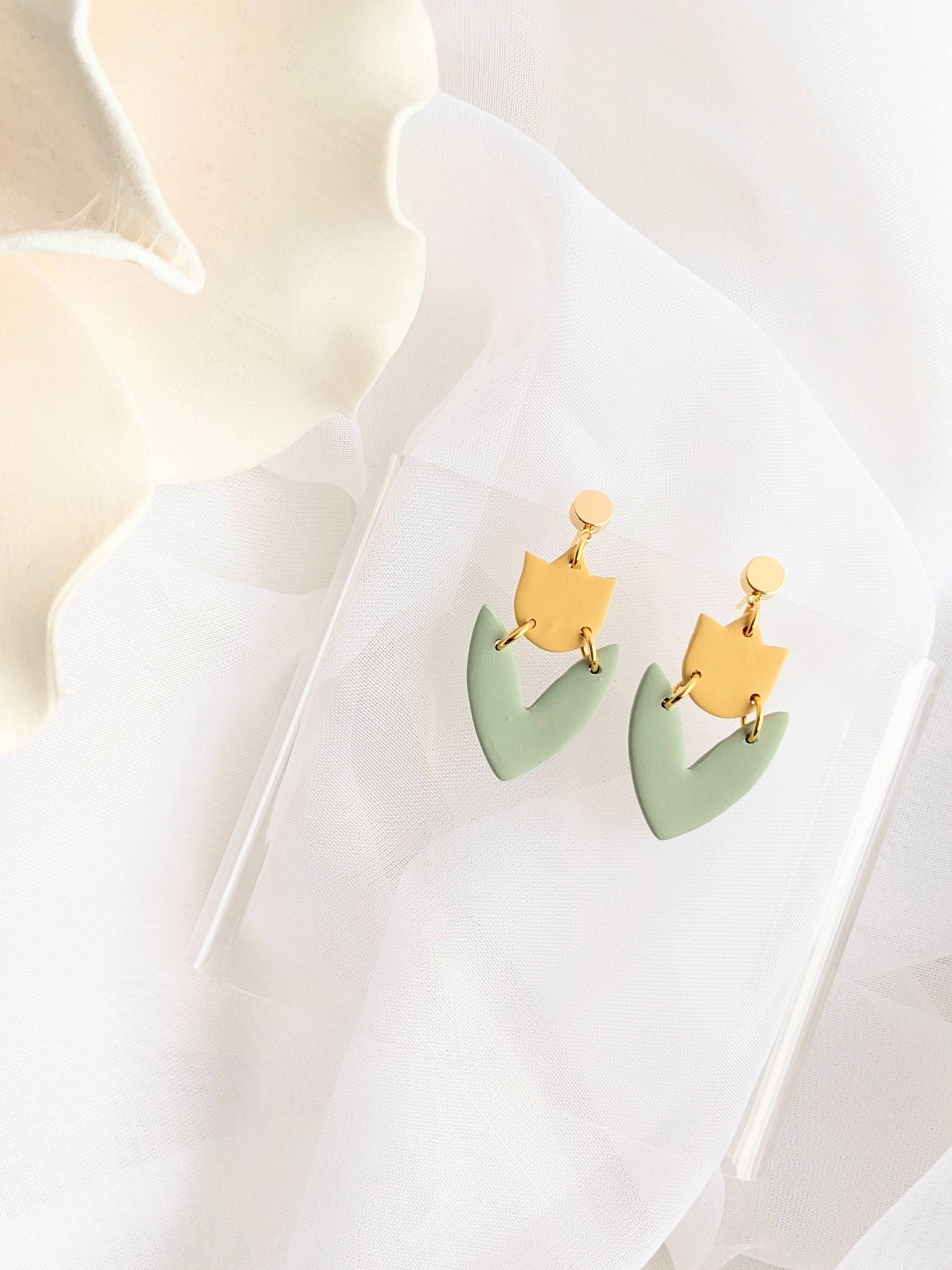 Artisan handmade polymer clay drop earrings in blue with modern cutout design, hypoallergenic and lightweight.