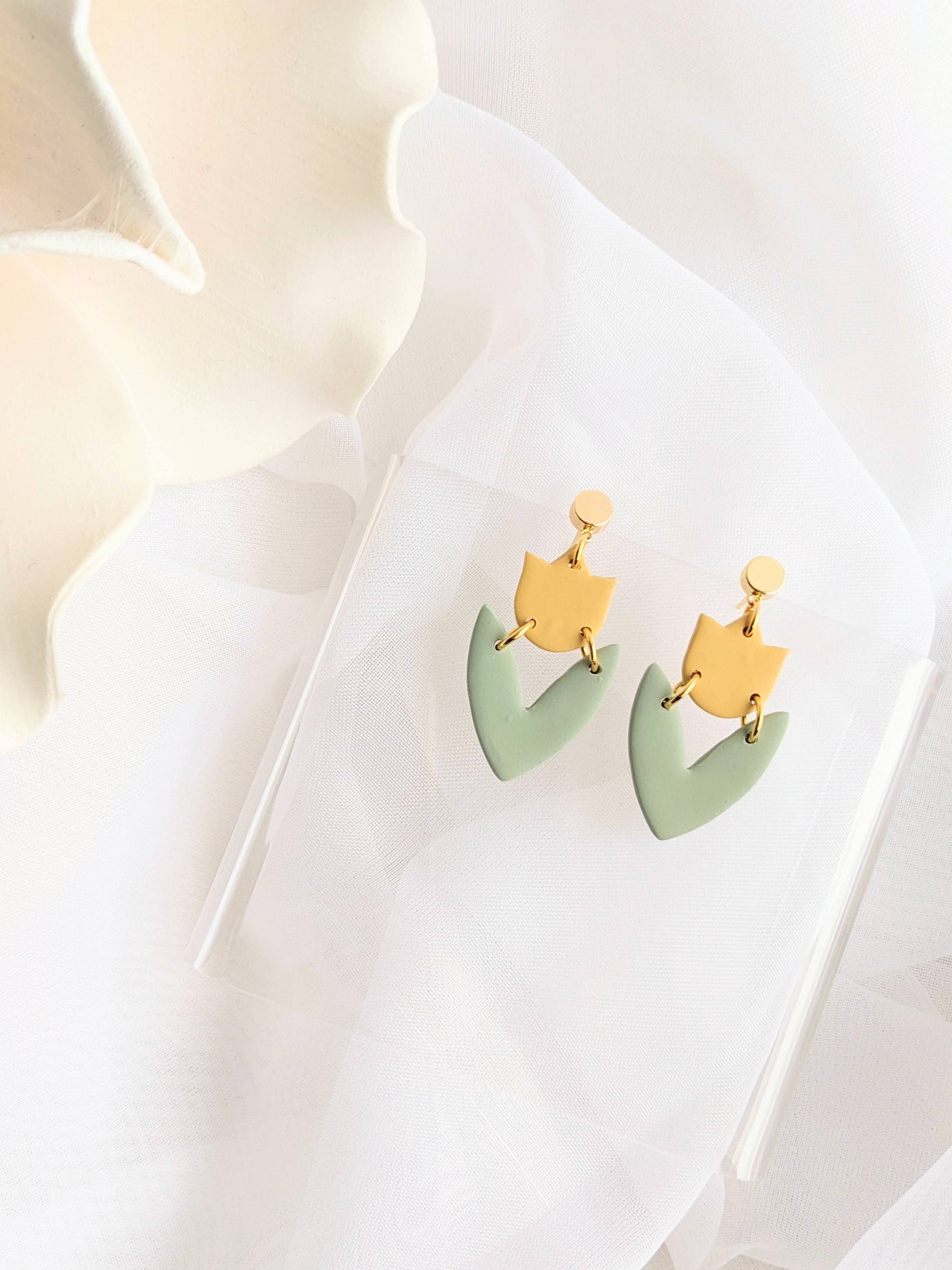 Artisan handmade polymer clay drop earrings in blue with modern cutout design, hypoallergenic and lightweight.