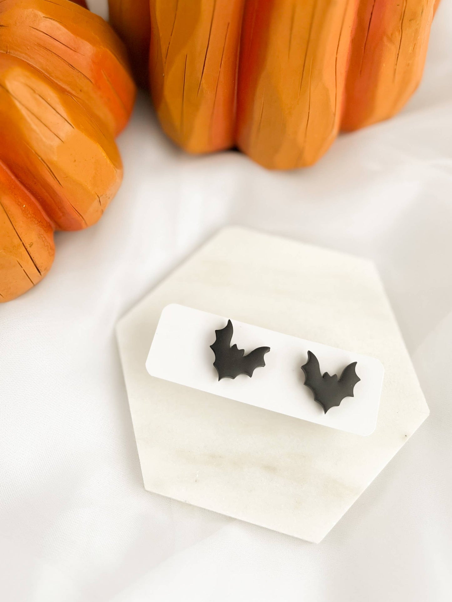 Pair of Bat Stud Earrings, featuring handmade matte black polymer clay bat silhouettes