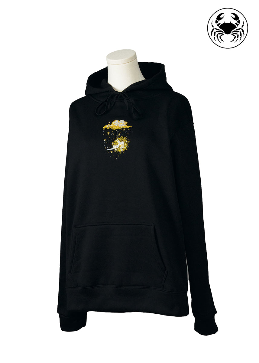 Front angled view of black hoodie with golden embroidered fairy swinging beneath a glowing cloud, Canadian apparel