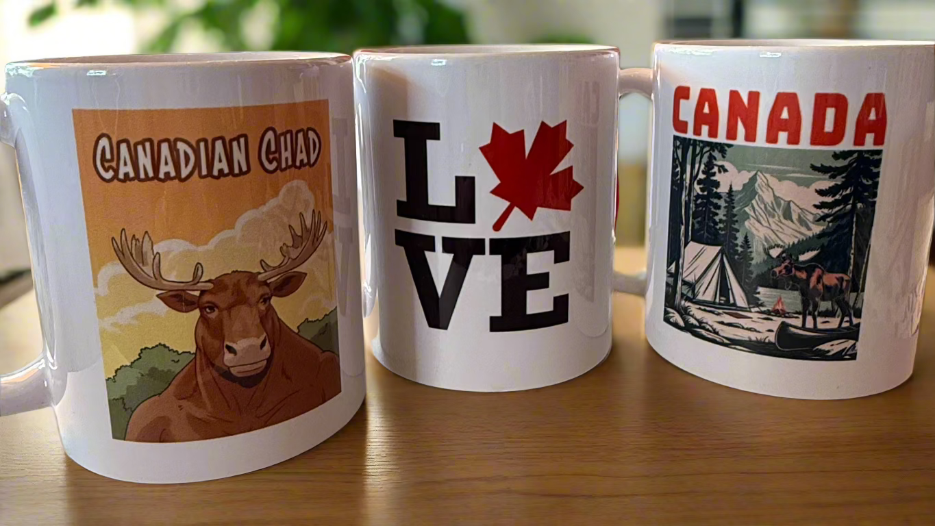 Three Canada-themed coffee mugs – Canadian Chad, LOVE maple leaf, and wilderness camping designs