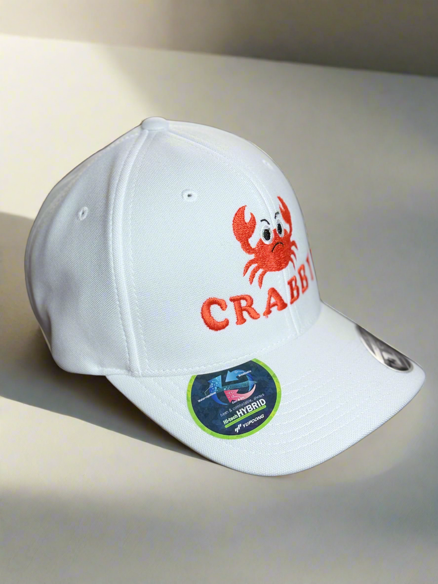 White structured Flexfit cap with bold orange crab and pink CRABBY embroidery