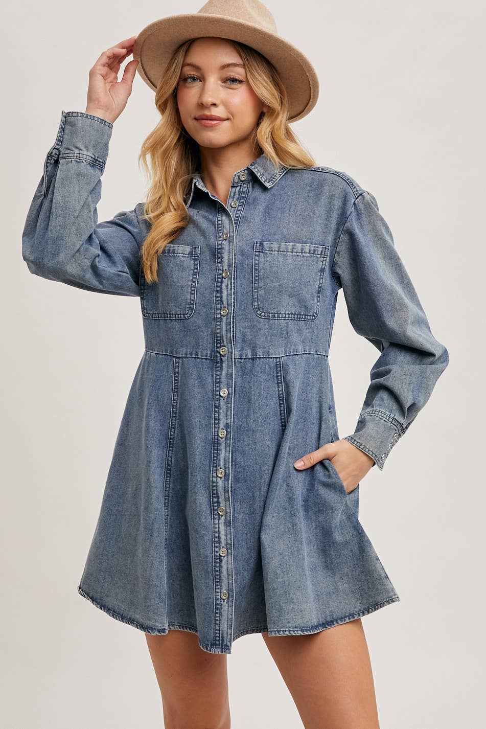 Denim shirt dress front pose, model wearing a hat, hands in pocket, long sleeves, button-up style