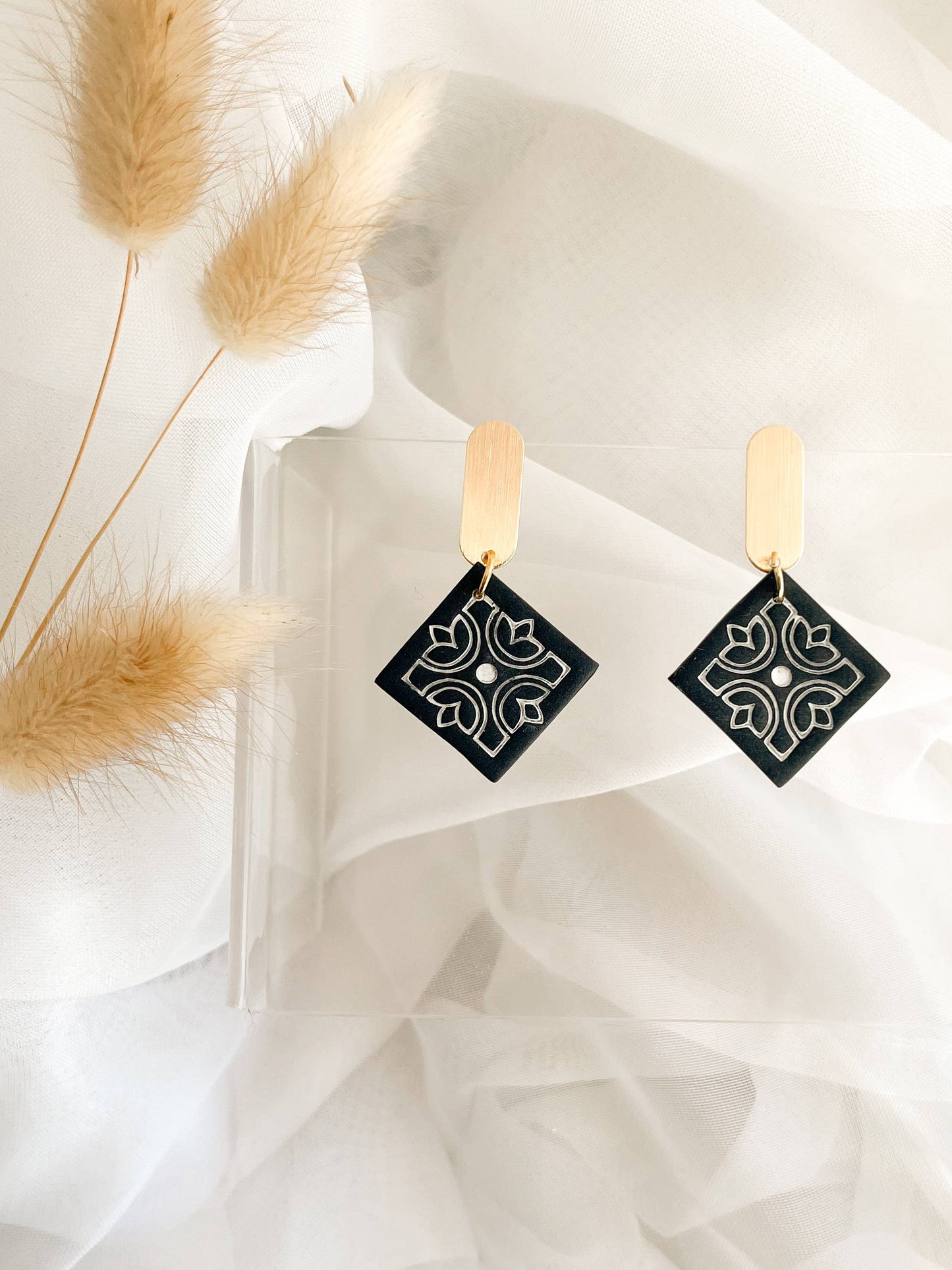 Intricate mandala-pattern polymer clay earrings, handmade and hypoallergenic, lightweight artisan jewelry.