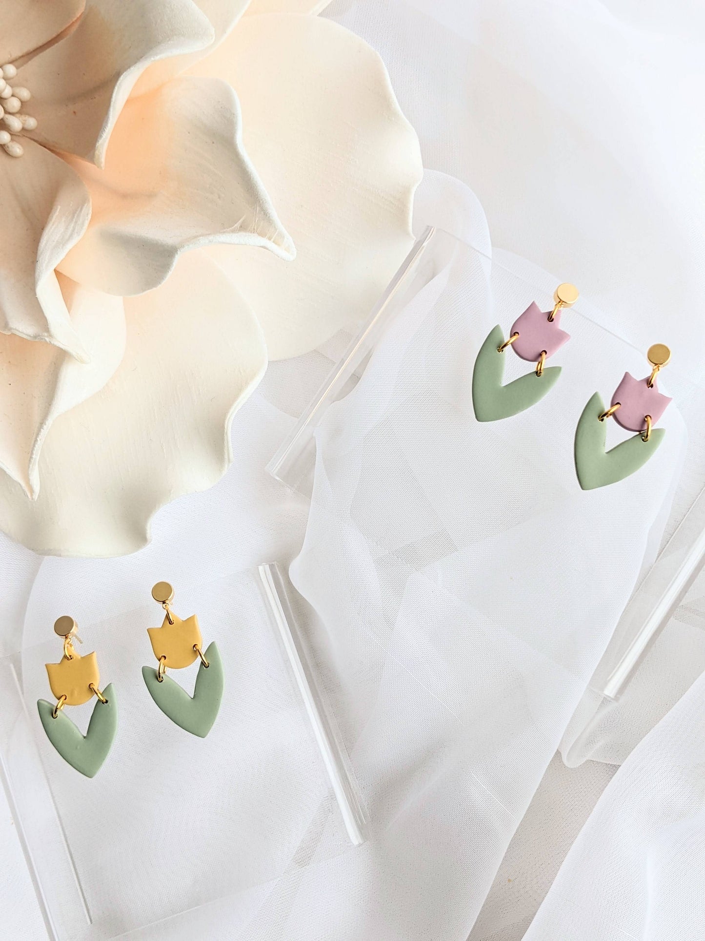 Handmade teal polymer clay earrings with floral embossed design, lightweight and hypoallergenic, crafted in Canada.