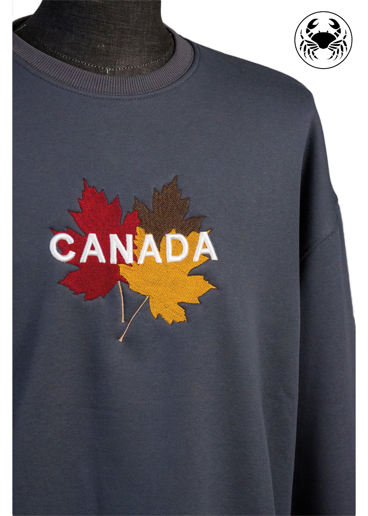 Closeup view of grey sweatshirt with 3D puff "CANADA"  Embroidery on fall maple leaf 