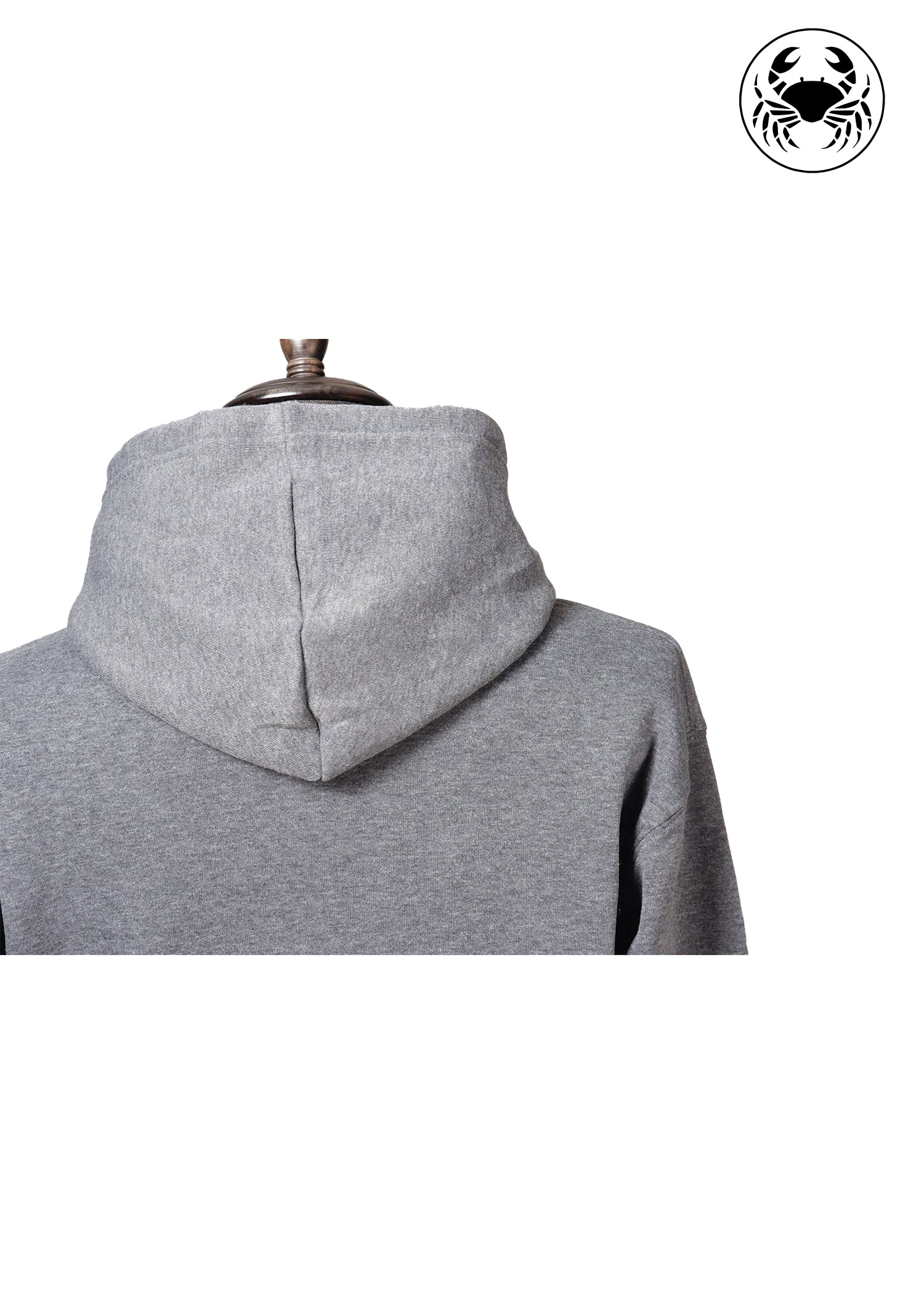 Back view of Unisex charcoal gray fleece hoodie with a front kangaroo pocket, drawstring hood, and a chest graphic featuring a mushroom, and botanical leaves