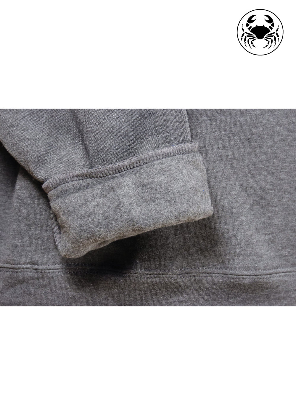closeup view of fleece fabric of charcoal gray fleece hoodie with a chest graphic featuring a mushroom in front