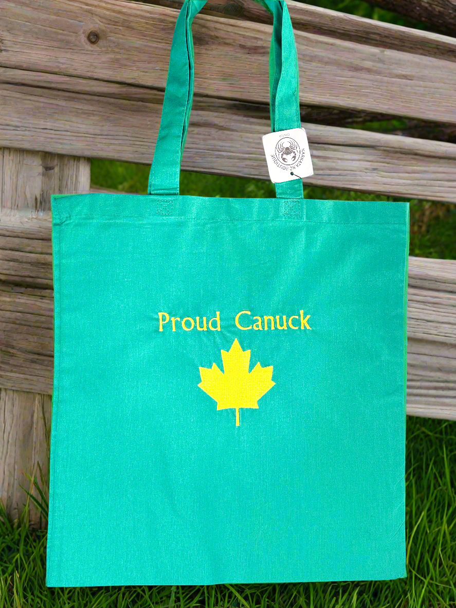Teal green embroidered tote bag with ‘Proud Canuck’ text and a yellow maple leaf design