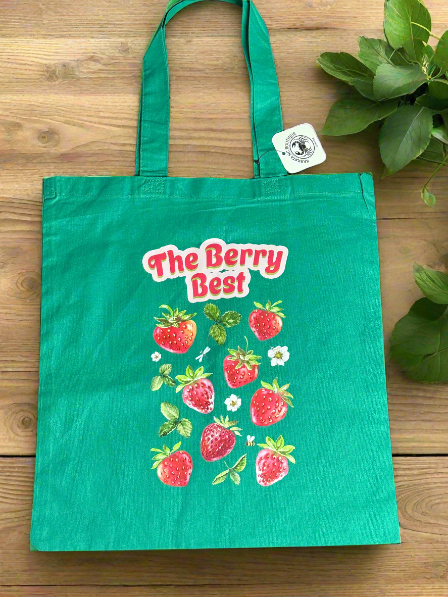 Green canvas tote bag with strawberry print and "The Berry Best" text