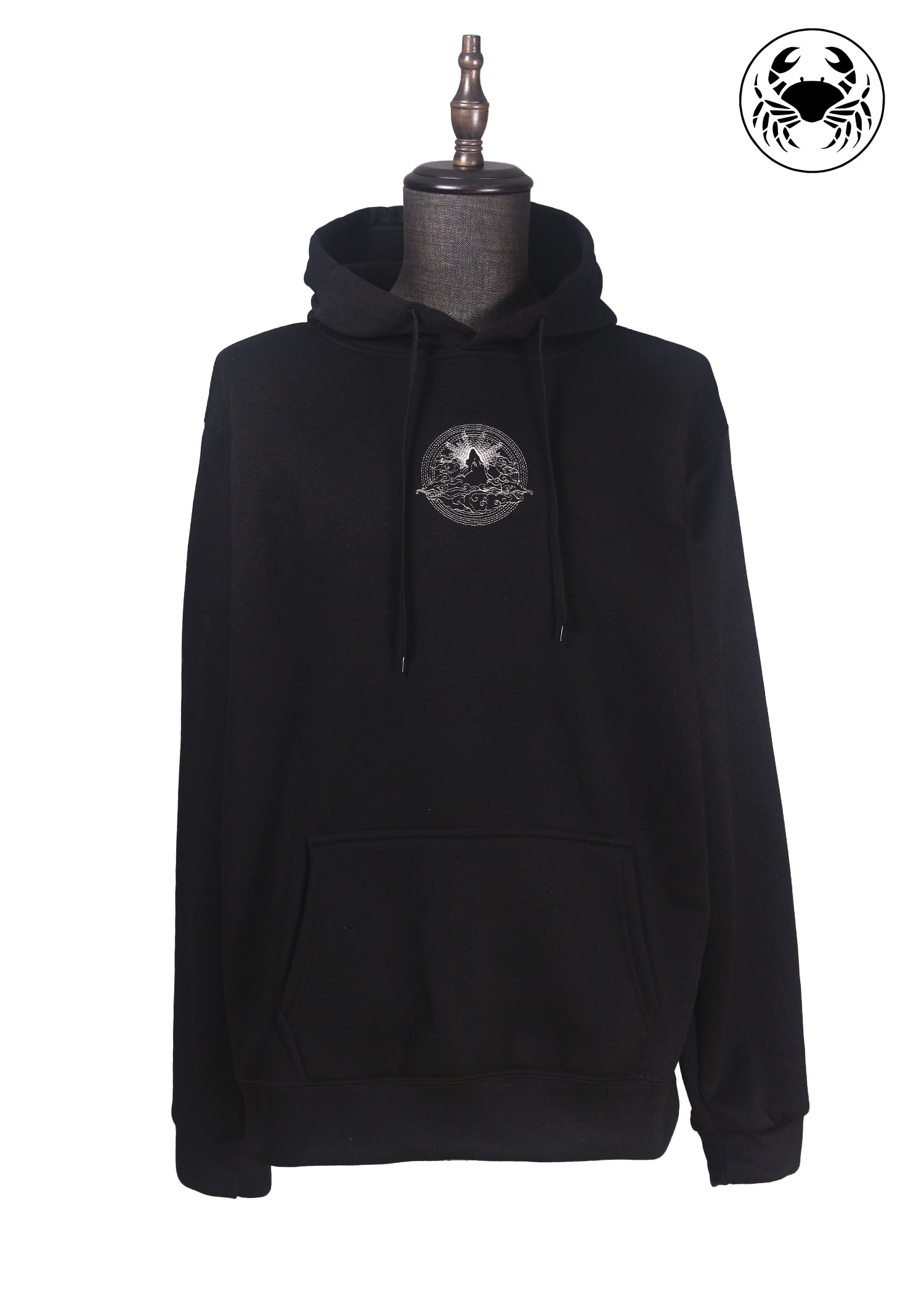 Front view of Unisex black fleece hoodie featuring a front kangaroo pocket, adjustable drawstring hood, and an embroidered  mountain and sun rising design 