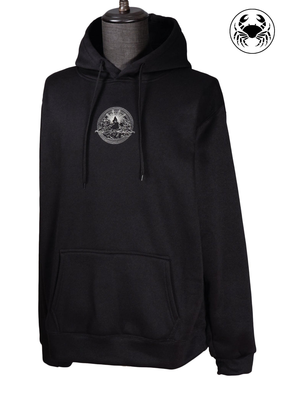 Wide view of Unisex black fleece hoodie featuring a front kangaroo pocket, adjustable drawstring hood, and embroidered  mountain and sun rising design