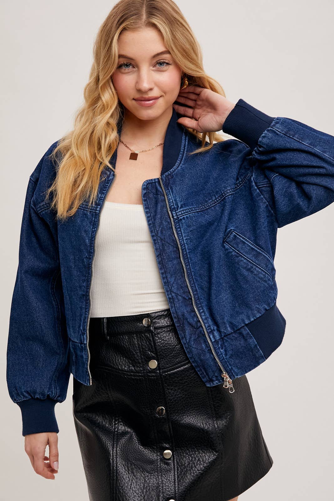 Angled side view of Karkata NC Boutique women's denim bomber jacket with zipper front