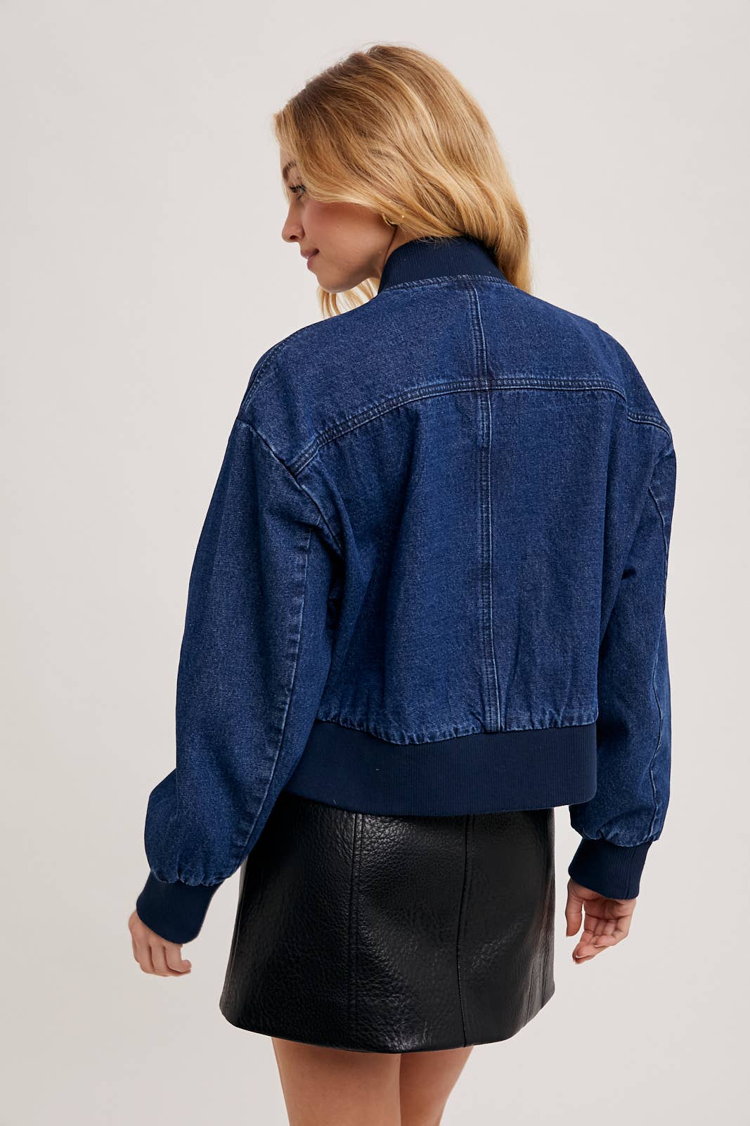 Back view of Karkata NC Boutique denim blue bomber jacket with ribbed waistband and cuffs