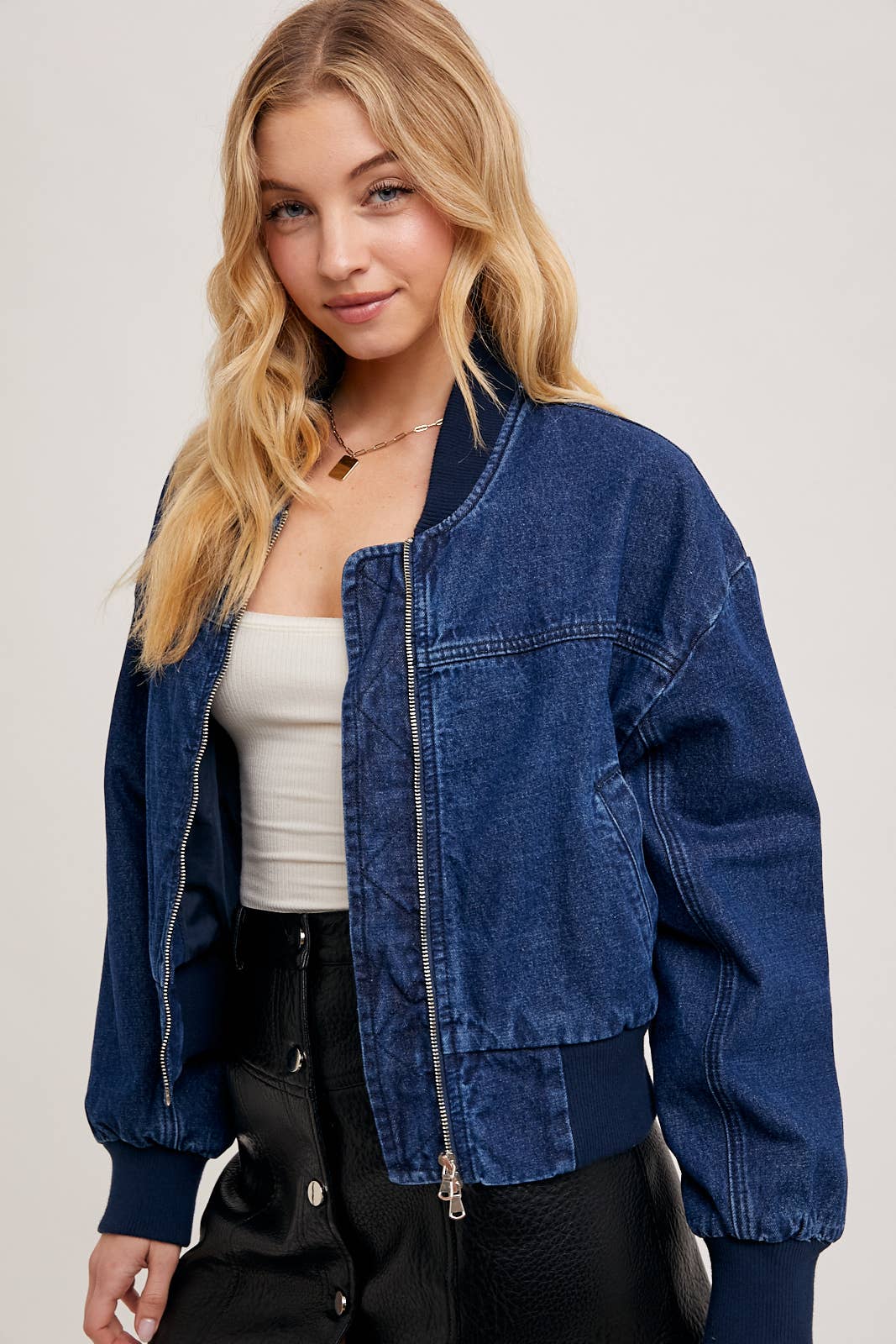 Close-up of denim blue bomber jacket from Karkata NC Boutique