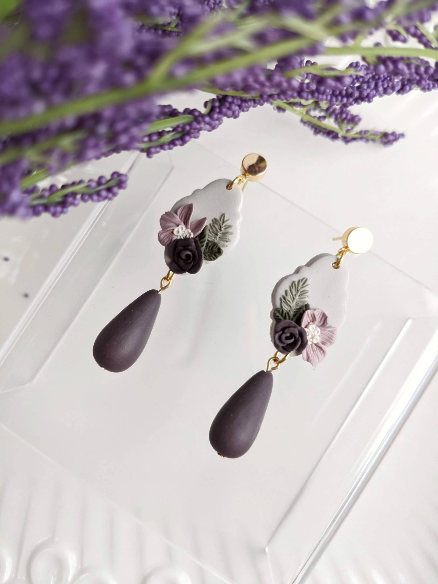 Handmade polymer purple floral clay earrings with hypoallergenic stainless steel posts, lightweight and comfortable for sensitive ears, crafted in Canada.