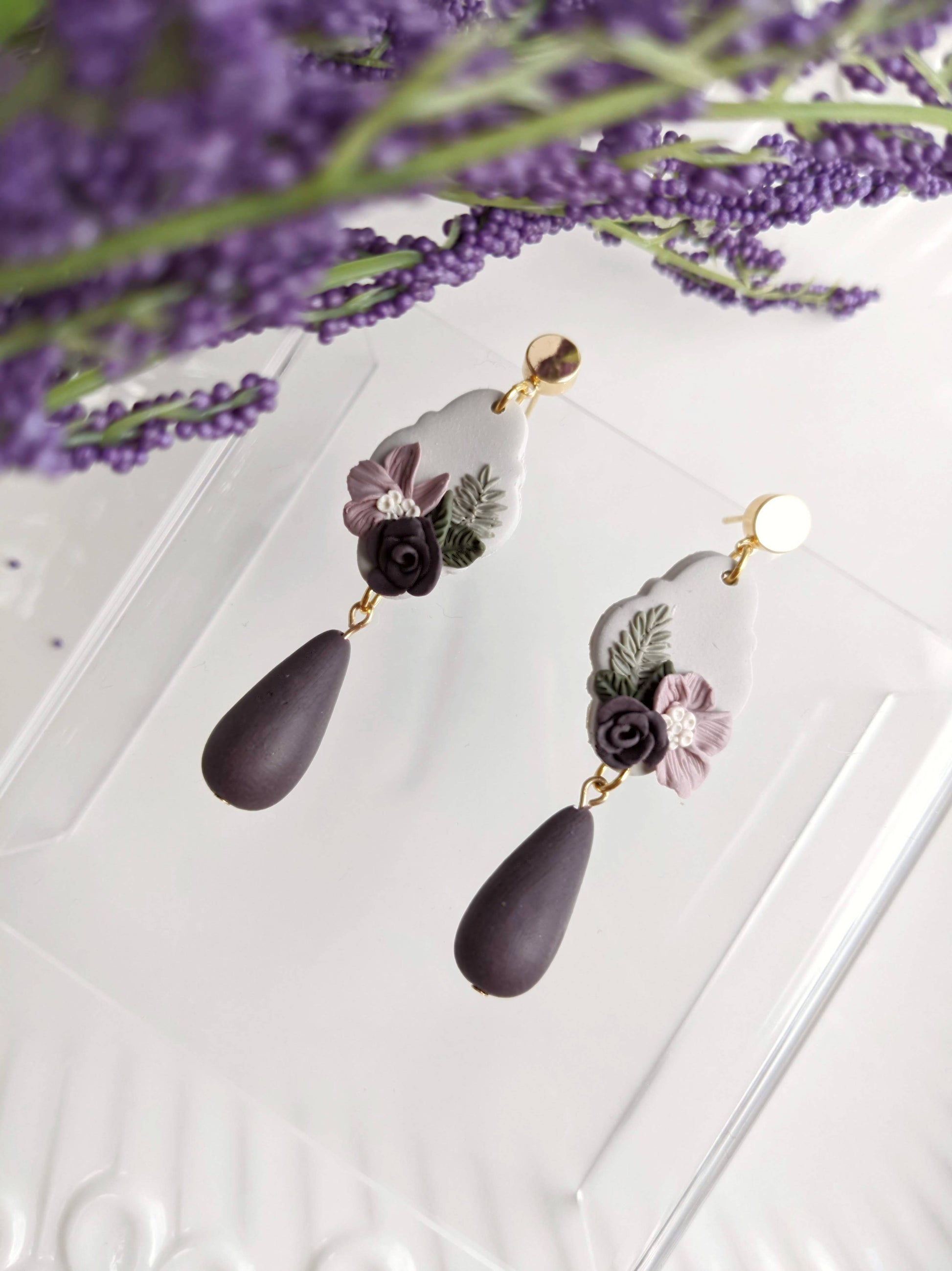 Handmade polymer purple floral clay earrings with hypoallergenic stainless steel posts, lightweight and comfortable for sensitive ears, crafted in Canada.