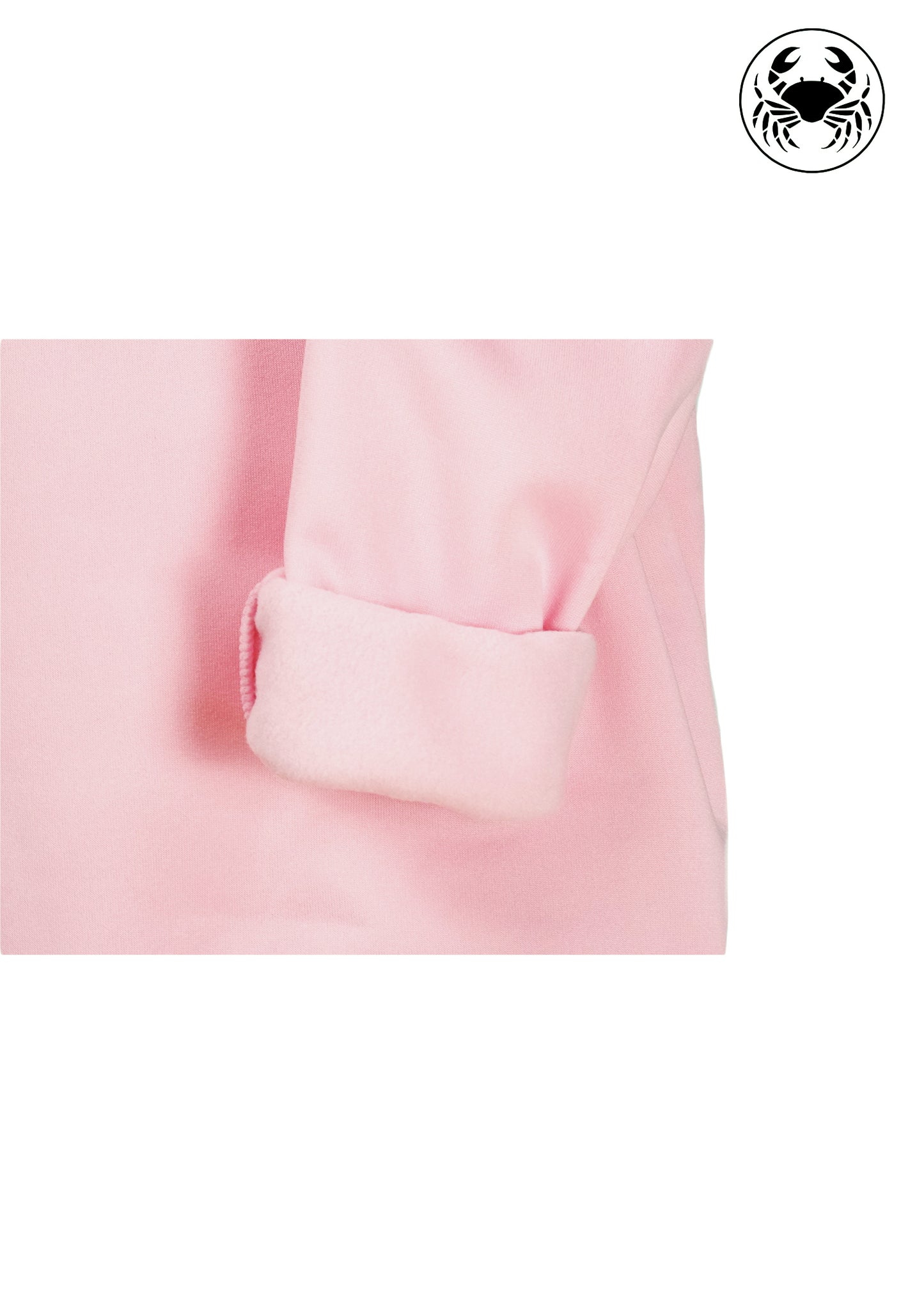 closeup view of fleece fabric of Light pink unisex crewneck sweatshirt featuring a embroidered heart design on the chest, long sleeves, ribbed cuffs and hem