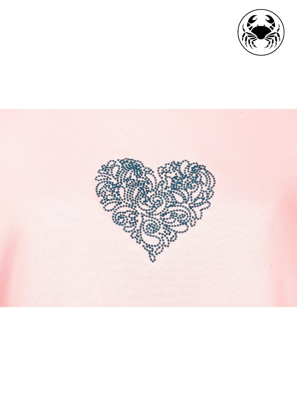 Close up of embroidered heart design on the chest, long sleeves, ribbed cuffs and hem