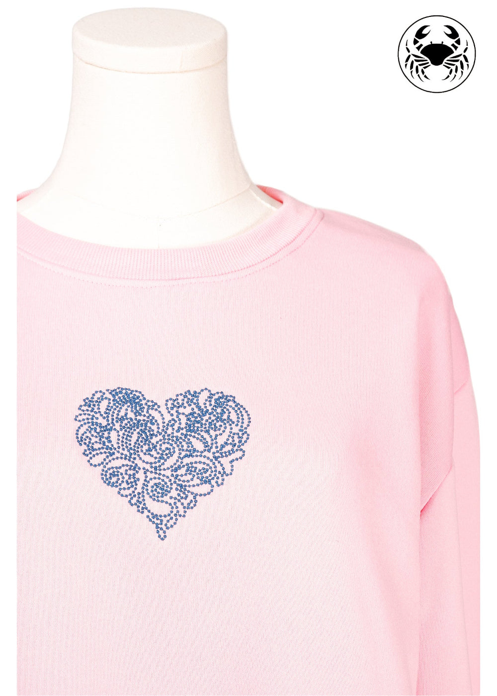Light pink unisex crewneck sweatshirt featuring a embroidered heart design on the chest, long sleeves, ribbed cuffs and hem