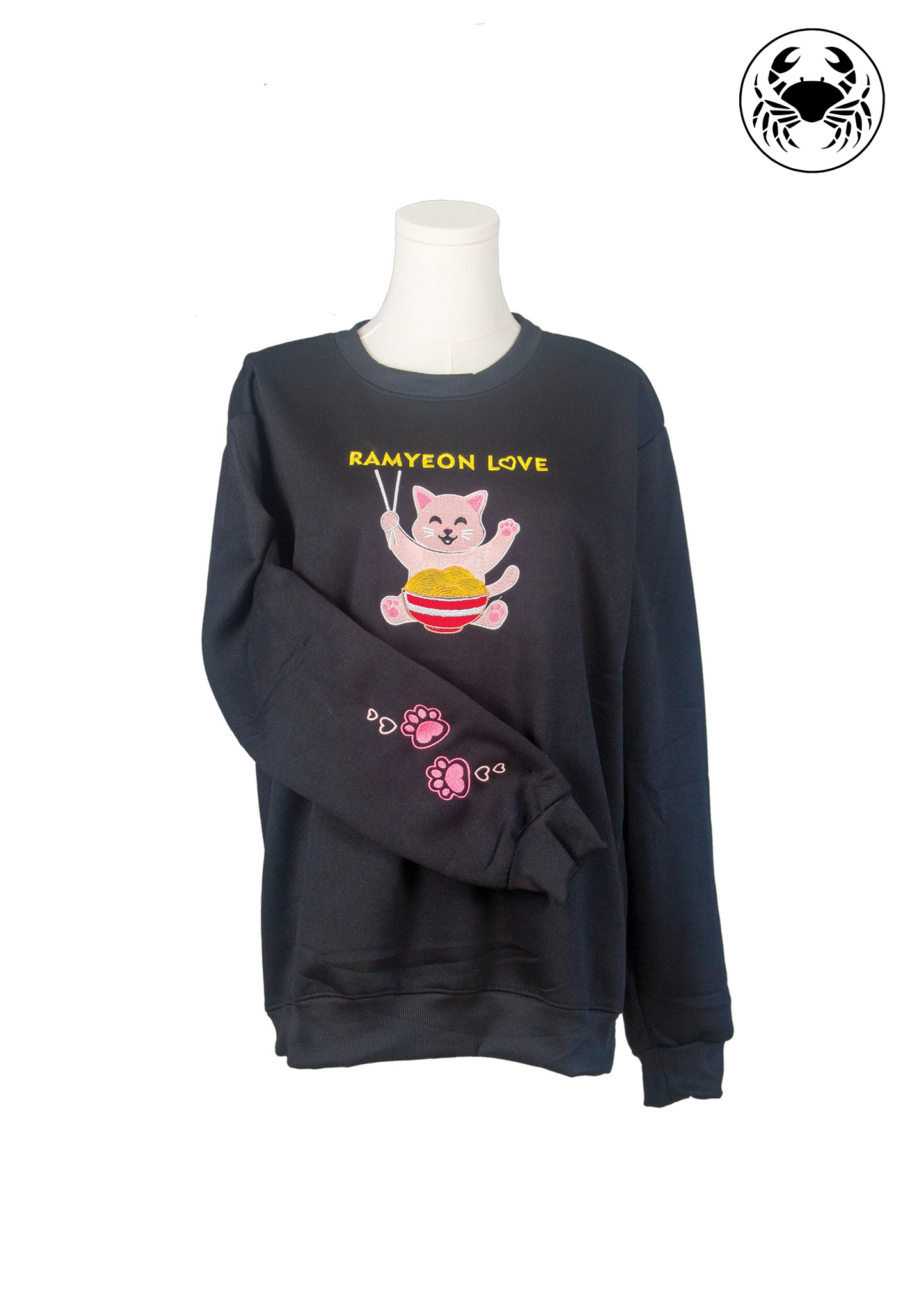 Closeup of sleeve showing pink paw print embroidery on Karkata unisex black kawaii ramyeon cat hoodie