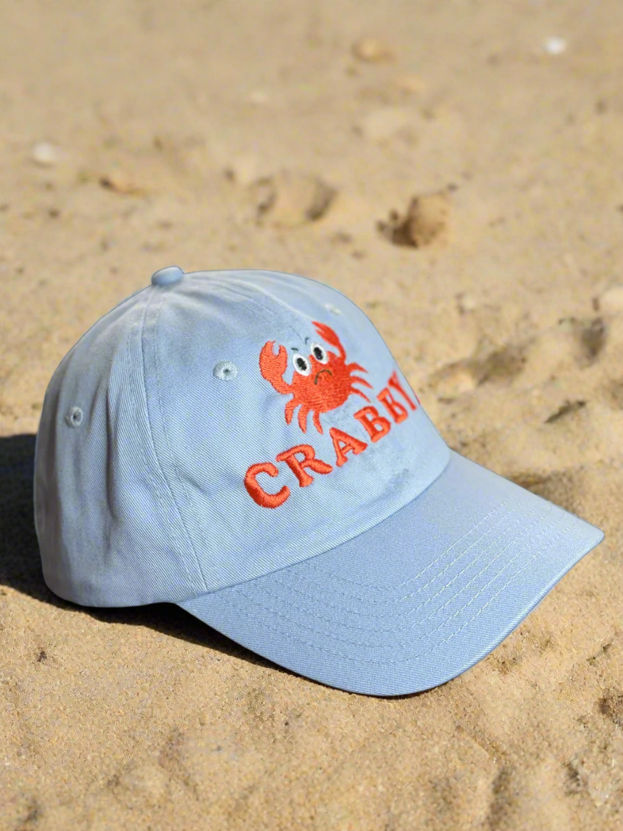 Light blue cap with red crab and 'CRABBY' embroidered in bold red