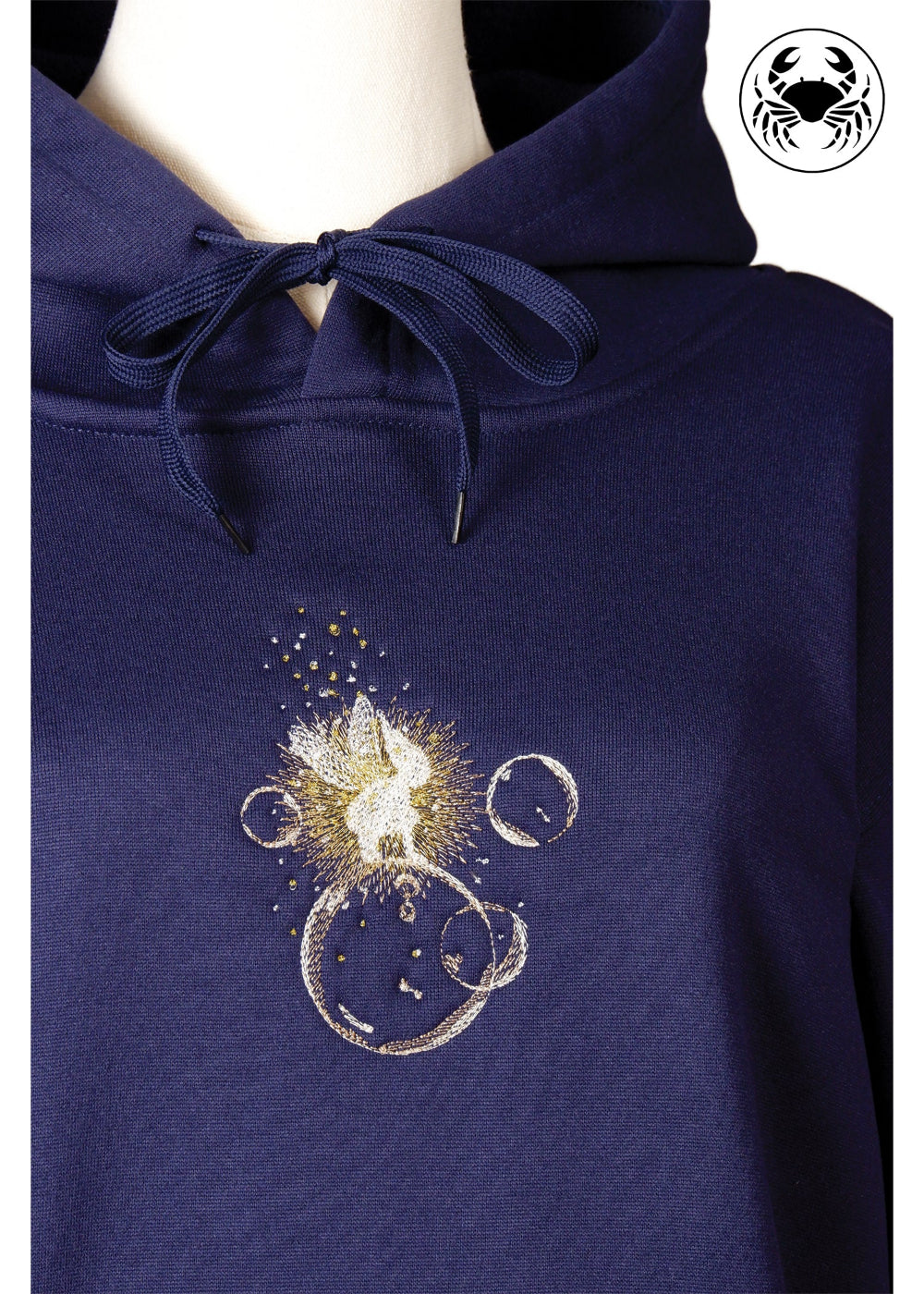 Close-up of embroidered fairy sitting on bubbles on navy blue hoodie, Canadian apparel