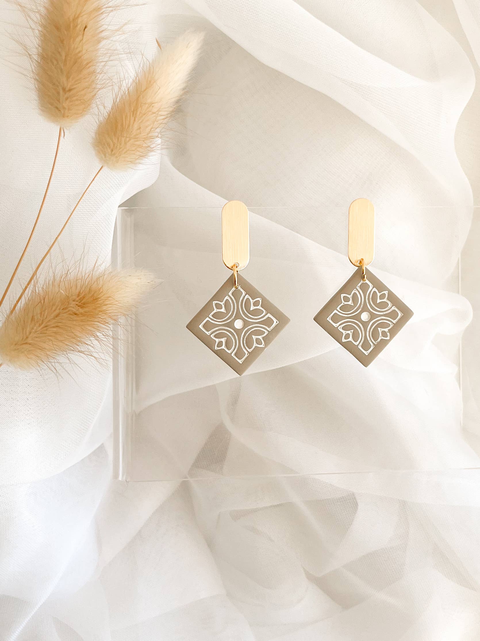 Handmade polymer clay earrings with gold-tone accent hooks, hypoallergenic and unique artisan design.