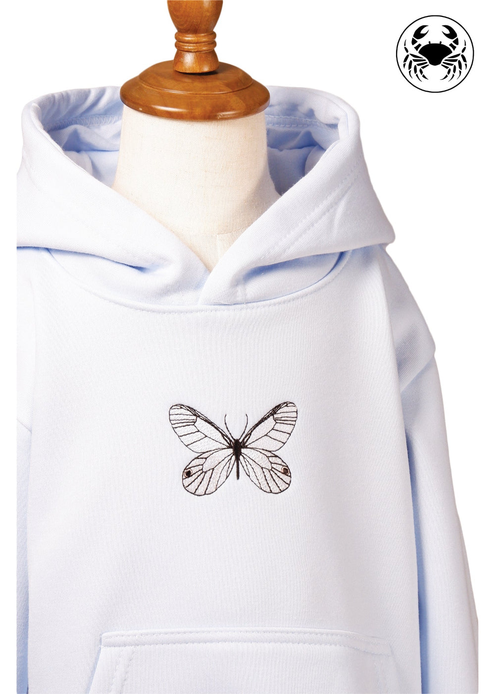 Front close up view of sky blue hoodie for kids with embroidered butterfly design, Canadian apparel