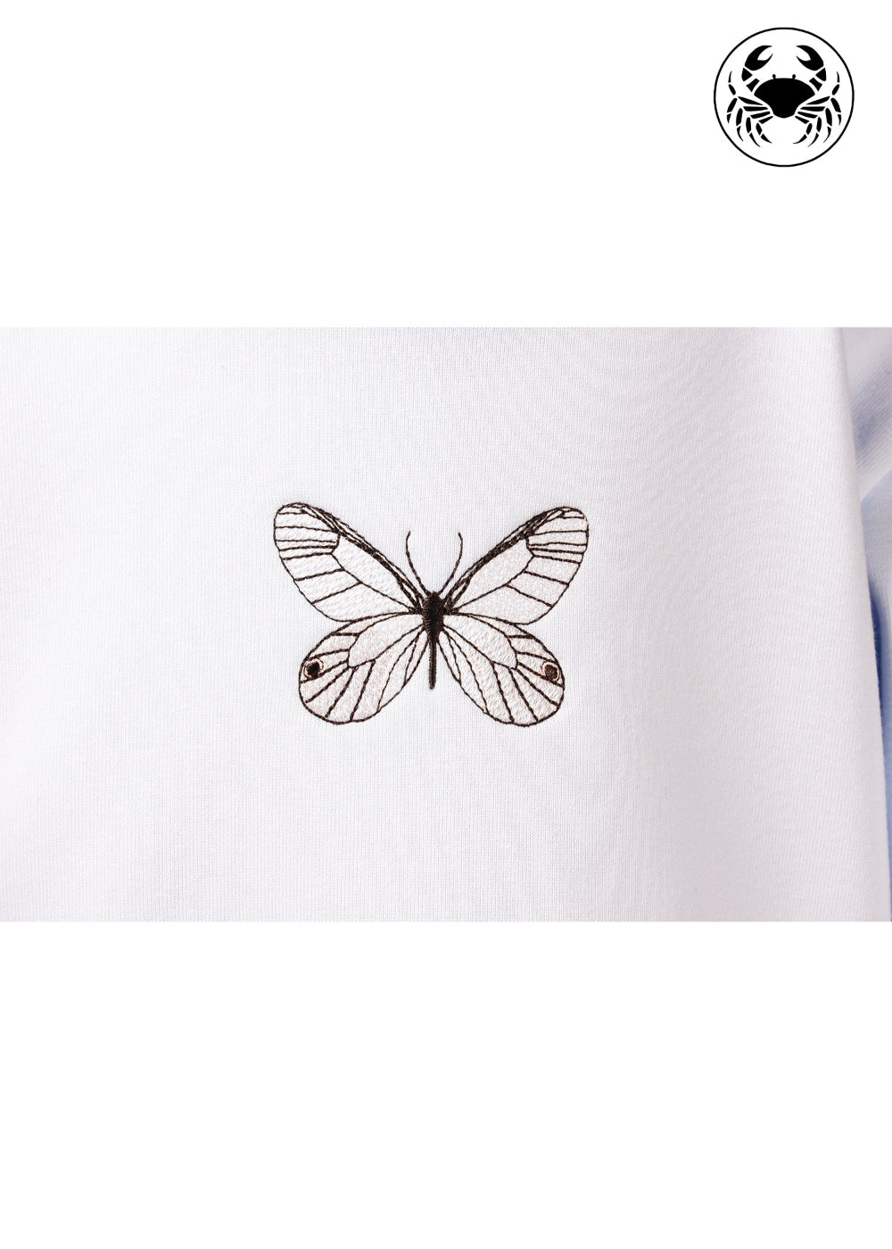 Close-up of embroidered butterfly design on sky blue kids hoodie, Canadian apparel