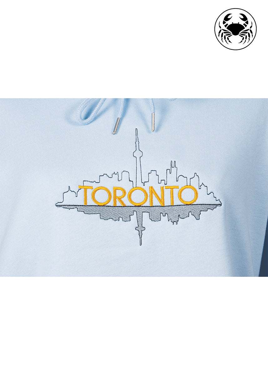 Close-up of embroidered Toronto skyline outline on sky blue hoodie, Canadian apparel