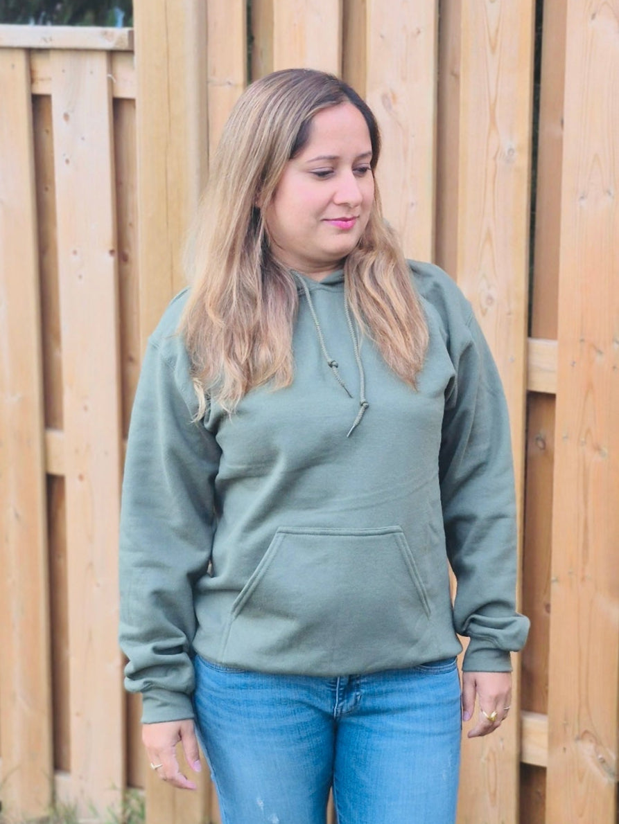 front view of Female model wearing unisex military green hoodie with drawstring hood and pocket